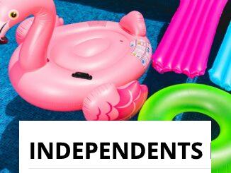 Bright inflatable flamingo and rings floating in a sunny pool.